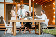 © rh2010 - Young friends having fun during the dinner on the backyard of the modern wooden country house outdoors