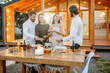 © rh2010 - Four friends enjoying evening time having a dinner on the backyard of the modern country house outdoors