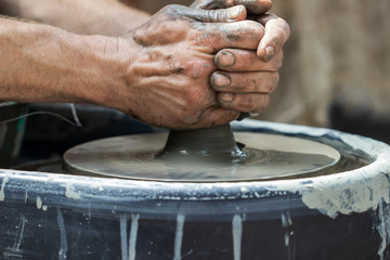 Master class on modeling of clay on a potter's wheel In the pottery workshop