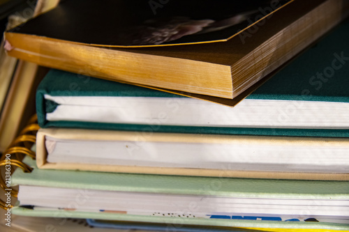 Fotografie, Obraz Stack of assorted hardback and paperback books or journals - some with bookmarks