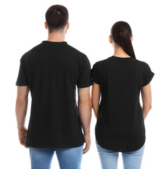 Wall Mural - Young couple in t-shirts on white background. Mockup for design