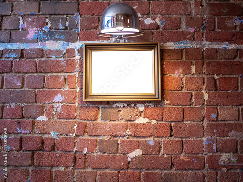 Mock up blank wooden picture frame hanging on grungy old red brick ...