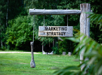 Wall Mural - Marketing Strategy concept. inscription on a wooden announcment board outdoars at countryside