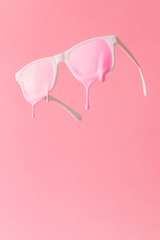 Wall Mural - Pink paint dripping out of white painted sunglasses. Creative fashion minimal concept.