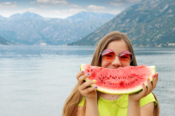 happy girl with sunglasses and watermelon on summer vacation