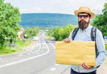 Pick Me Up. Man Bearded Hitchhiker Stand At Edge Of Road With Blank Paper Sign, Copy Space. Benefits Using Sign With Name Destination. Cardboard Sign With Indication Where You Want Go