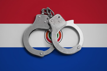 Paraguay flag  and police handcuffs. The concept of observance of the law in the country and protection from crime