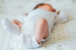 © kaloriya - Little feet of a newborn child in white socks