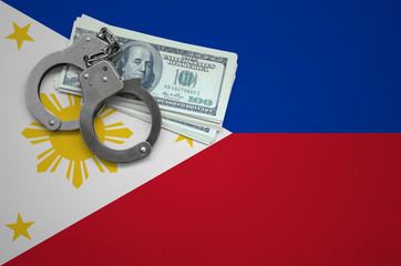 Wall Mural - Philippines flag  with handcuffs and a bundle of dollars. The concept of breaking the law and thieves crimes