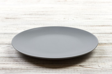 Poster - Perspective view. Empty Gray round plate on wooden background