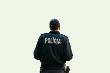 Isolated on white background a policeman is standing with his back in special clothes with the inscription Police in Portuguese and Slovak