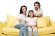 © LIGHTFIELD STUDIOS - portrait of cheerful family in white shirts on yellow sofa isolated on white