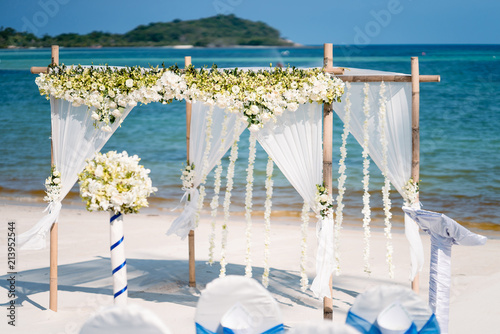 Bouquet Foreground With Beautiful Beach Wedding Arch Setting With