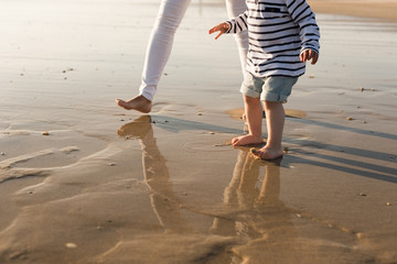 Wall Mural - Mother at the beach with toddler