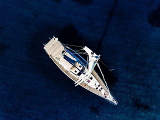 Wall Mural - Aerial birds eye view from drone of yacht in deep blue sea