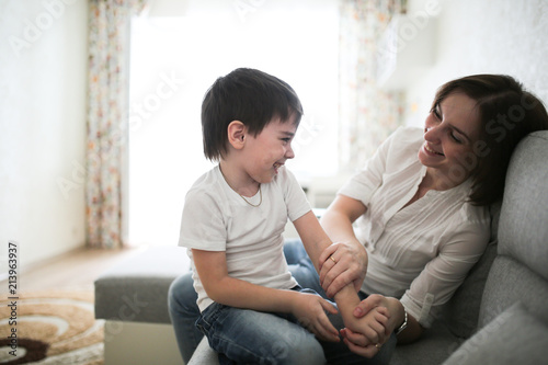 Beautiful Brunette Mom And Son Hugging Sofa Beautiful Brunette Mom And Son Hugging Sofa