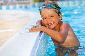 Sticker - Smiling boy standing in water of swimming pool