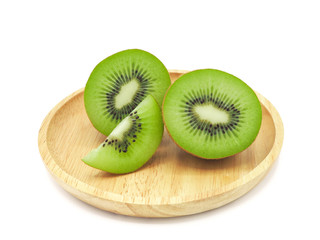 Slice of fresh juicy delicious and healthy kiwi fruit on wooden plate, isolated on white background.