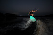 © fesenko - Athletic wakesurfer riding down the river at summer night