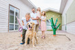 © LIGHTFIELD STUDIOS - parents and children standing with adopted labrador at animals shelter