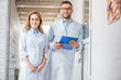 © LIGHTFIELD STUDIOS - two veterinarians in white coats standing in veterinary clinic and looking at camera