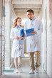 © LIGHTFIELD STUDIOS - vets in white coats walking in veterinary clinic and looking at clipboard