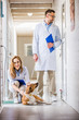 © LIGHTFIELD STUDIOS - male and female vets with dog at veterinary clinic