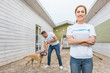 © LIGHTFIELD STUDIOS - volunteer of animals shelter playing with labrador dog, woman looking at camera