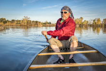 Paddling Canoe On Calm Lake