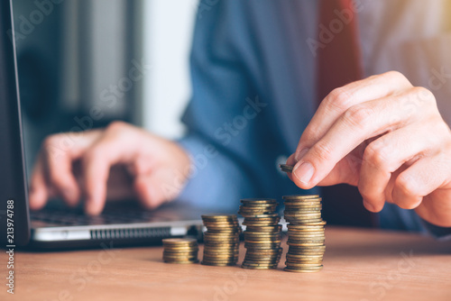 Fotomural Finances and budgeting, businessman stacking coins