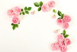 Flowers background. Beautiful pale pink roses frame on white background. Top view. Copy space. Flat lay.
