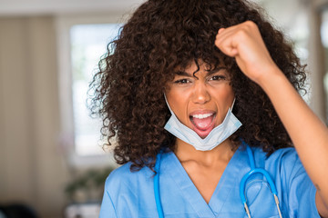 Sticker - African american woman medical professional annoyed and frustrated shouting with anger, crazy and yelling with raised hand, anger concept