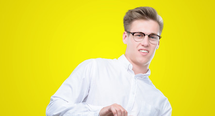 Wall Mural - Young handsome blond man disgusted expression, displeased and fearful doing disgust face because aversion reaction. With hands raised. Annoying concept.