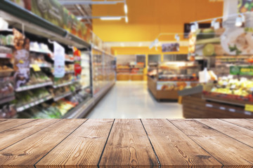 Empty wood table top on shelf in supermarket blurred background