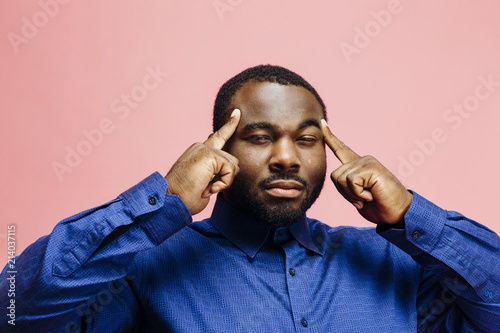 Fotografie, Obraz Horizontal portrait of a plus size man in blue shirt with fingers on temples, is