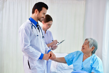 Wall Mural - Concept of healing care. The doctor is healing  old woman. The doctor is working in the hospital. Doctors encourage and treat elderly patients.