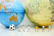 © keatikun - Miniature people : Soccer player man,football world championship cup concept.