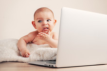 Small Baby Infant Working Playing Learning On The Laptop Wireless Serious Face