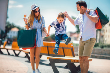 Happy family having fun outdoor after shopping