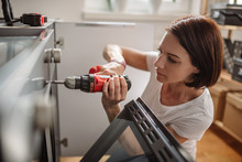 Woman Using A Cordless Drill