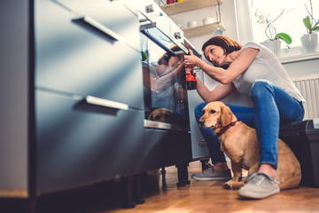 Wall Mural - Woman building kitchen and using a cordless drill