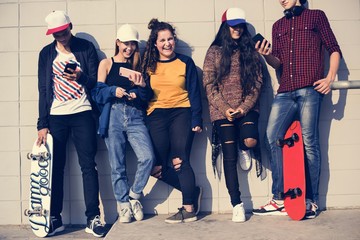 Wall Mural - Group of teenage friends outdoors lifestyle and social media concept