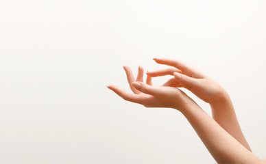 Closeup image of beautiful woman's hands with light pink manicure on the nails. Skin care for hands, manicure and beauty treatment. Elegant and graceful hands with slender graceful fingers