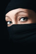 © nedim_b - Woman face close up with only eyes visible, rest of the face is covered with black scarf