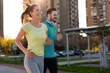 Young Fitness Couple Running In Urban Area