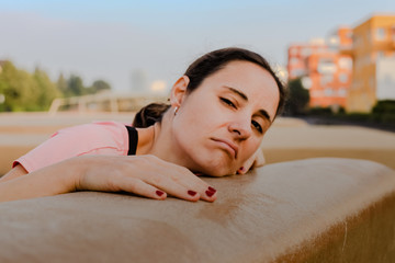 unmotivated and groggy sporty woman after fitness workout 