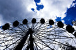 Ferris wheel in a cloudy sky