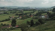 4 K Timelaps Frame Posterise Fasted Video With View Of Green Hills Countryside With Factory On It's Background, Green Trees And Grass, Ships, Smoking Pipes And Tranforming Clouds