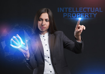 The concept of business, technology, the Internet and the network. A young entrepreneur working on a virtual screen of the future and sees the inscription: Intellectual property