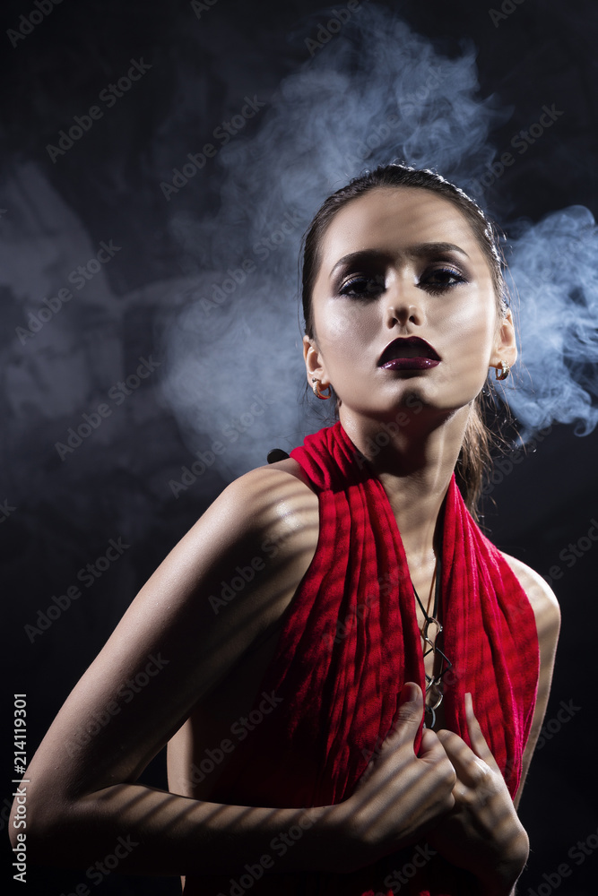 Beautiful brunette topless girl model, covering her naked breast with a red scarf and wearing a